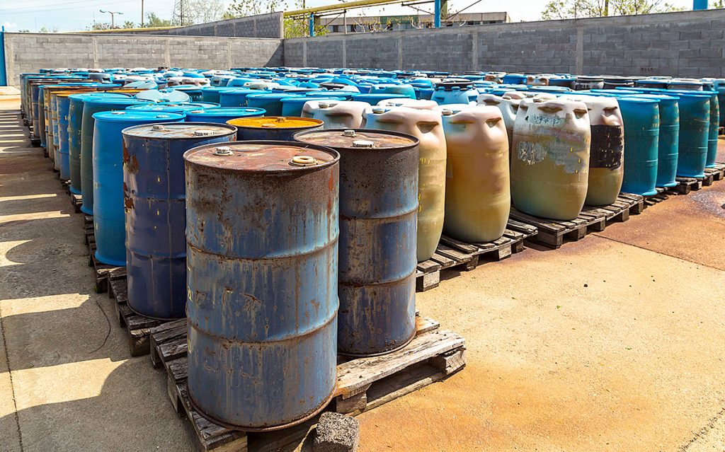 Metal barrels stored outside on palettes