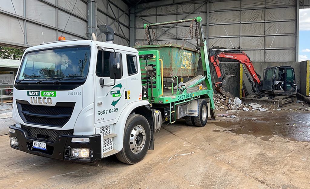A truck unloading at a waste station