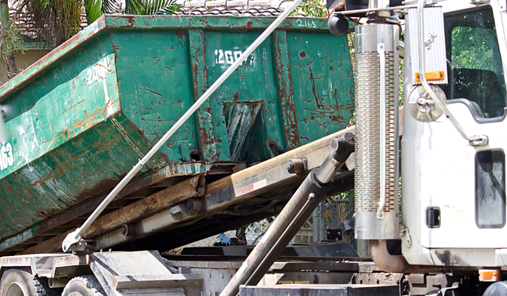 Commercial skip bin being loaded onto a collection truck for business waste removal.