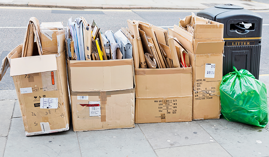 Cardboard boxes filled with flattened cardboard and paper ready for comingled recycling collection.