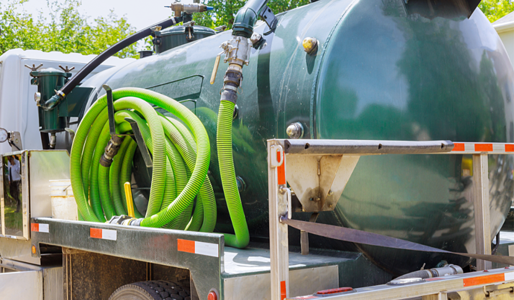 Liquid waste vacuum truck with hoses for commercial waste collection